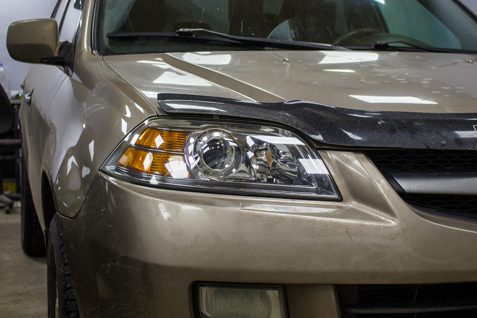 Зовнішній вигляд правої фари Acura MDX ПІСЛЯ заміни штатних лінз на Hella 5, шліфування, полірування та бронювання поліуретановою плівкою